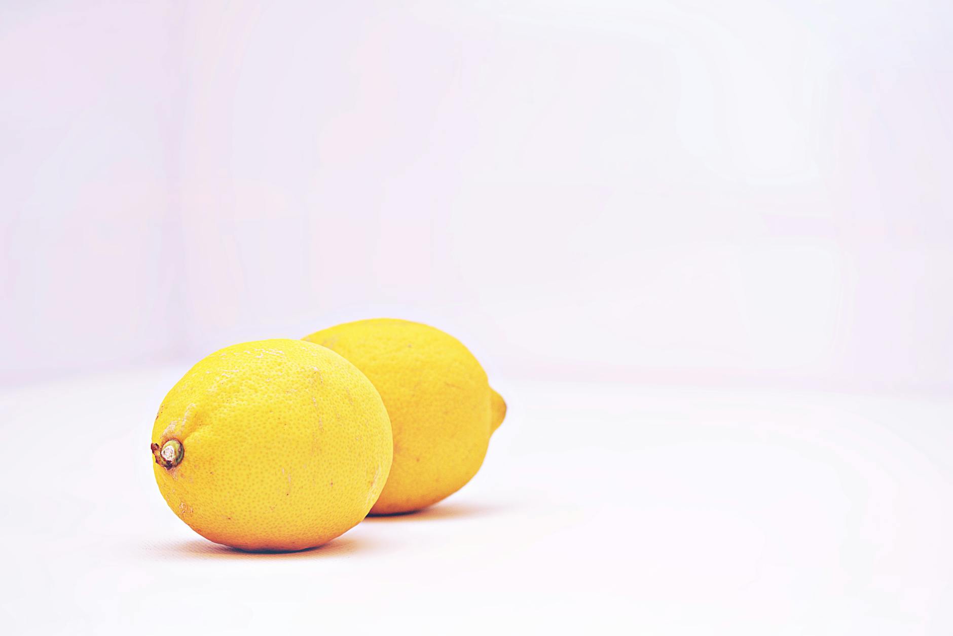 Two vibrant lemons on a white background, symbolizing the Lem vibrator for renewed pleasure