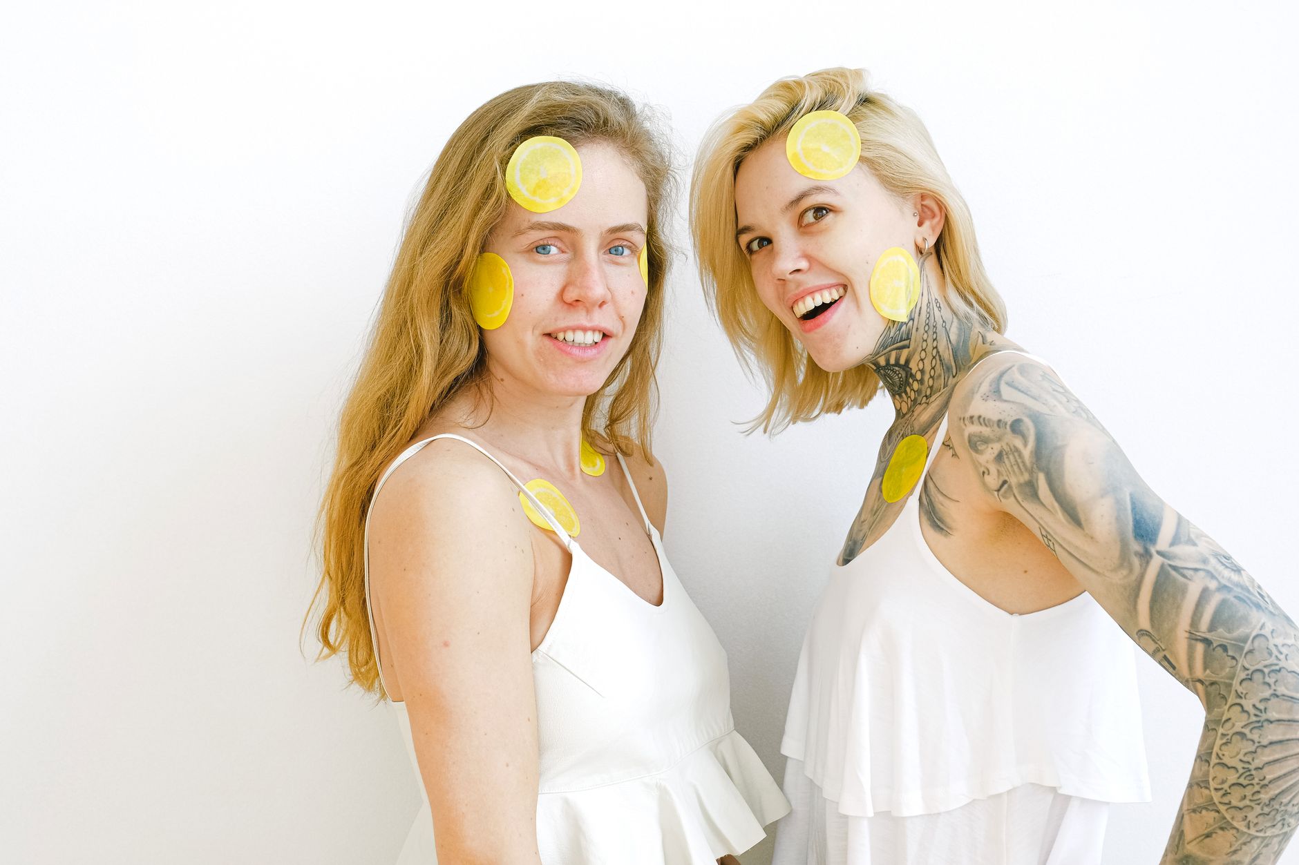 Hand holding an orange vibrator against a minimalistic backdrop, showcasing modern sensuality and intimate solo exploration