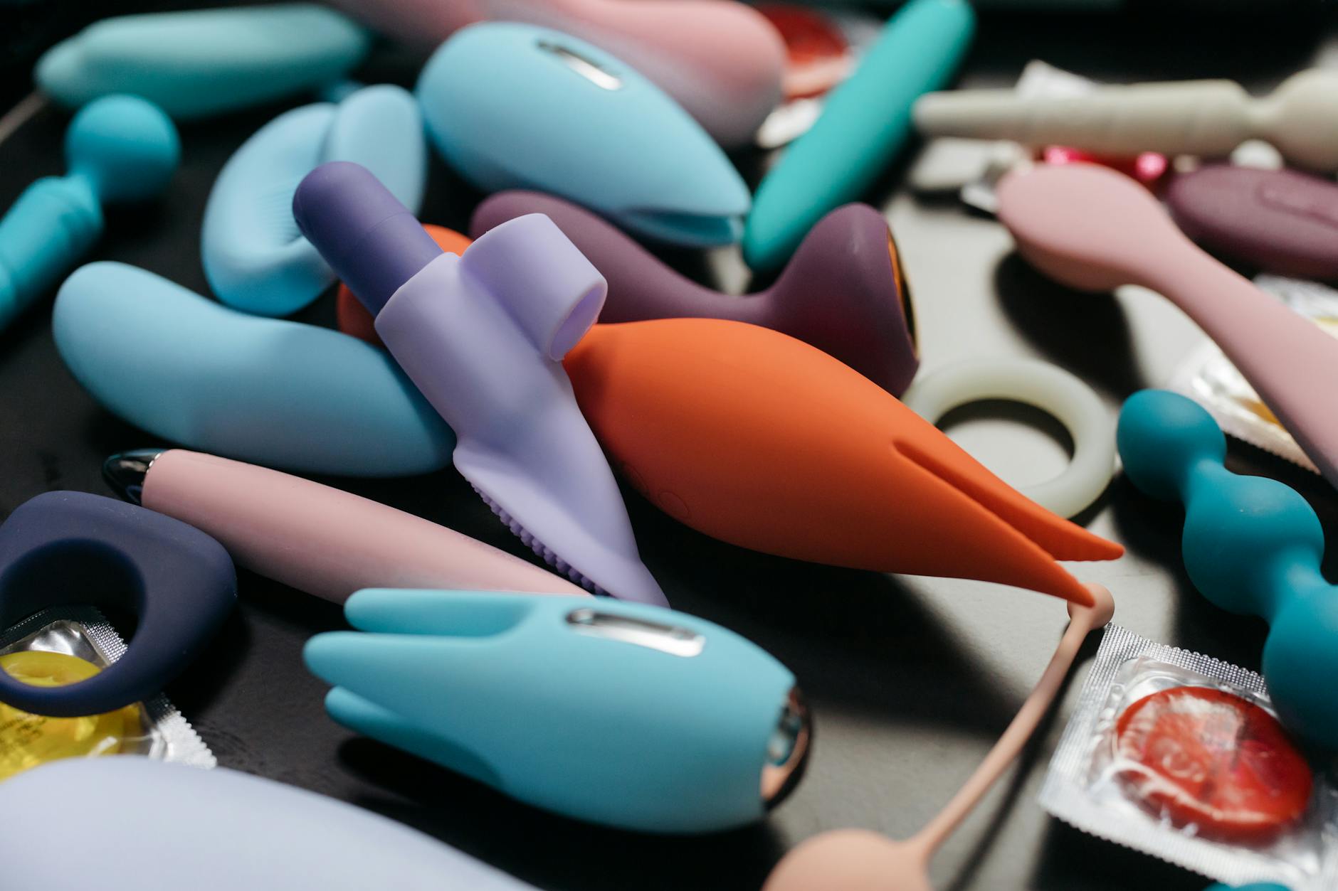 Vibrant array of colorful adult toys including vibrators displayed in close-up